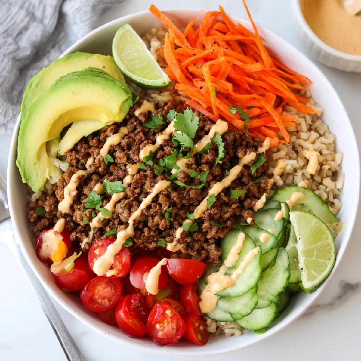 A colorful plant-based meat bowl filled with fresh veggies and zesty lime.  