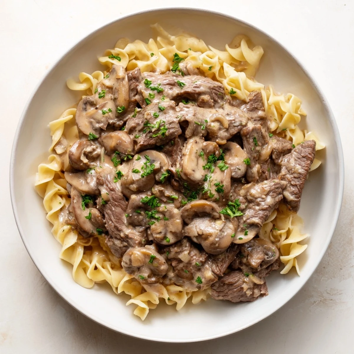 Golden egg noodles topped with creamy mushroom beef stroganoff, a classic comfort food.