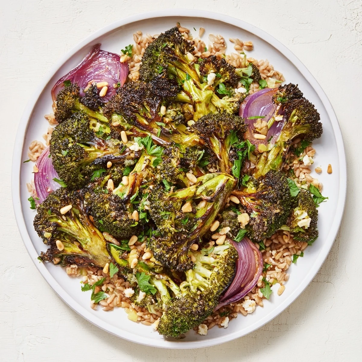 A flavorful Warm Roasted Broccoli with Garlic-Lemon & Farro dish, drizzled with tangy lemon dressing, ready to enjoy.