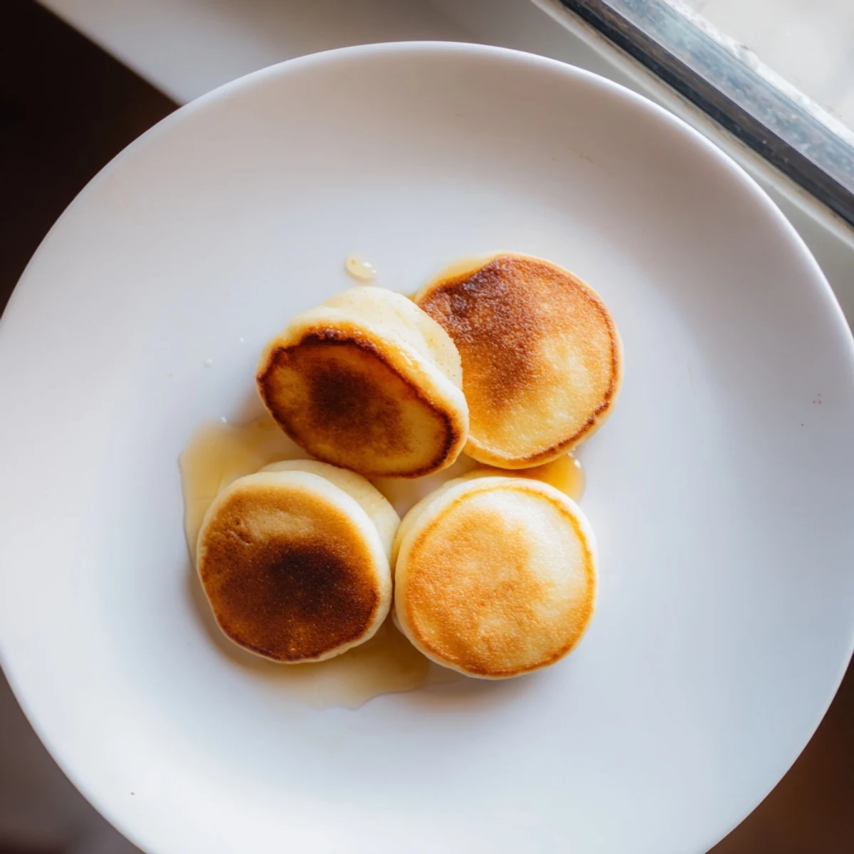Golden-brown pancake cereal in a bowl, awaiting milk and syrup for a delicious breakfast.
