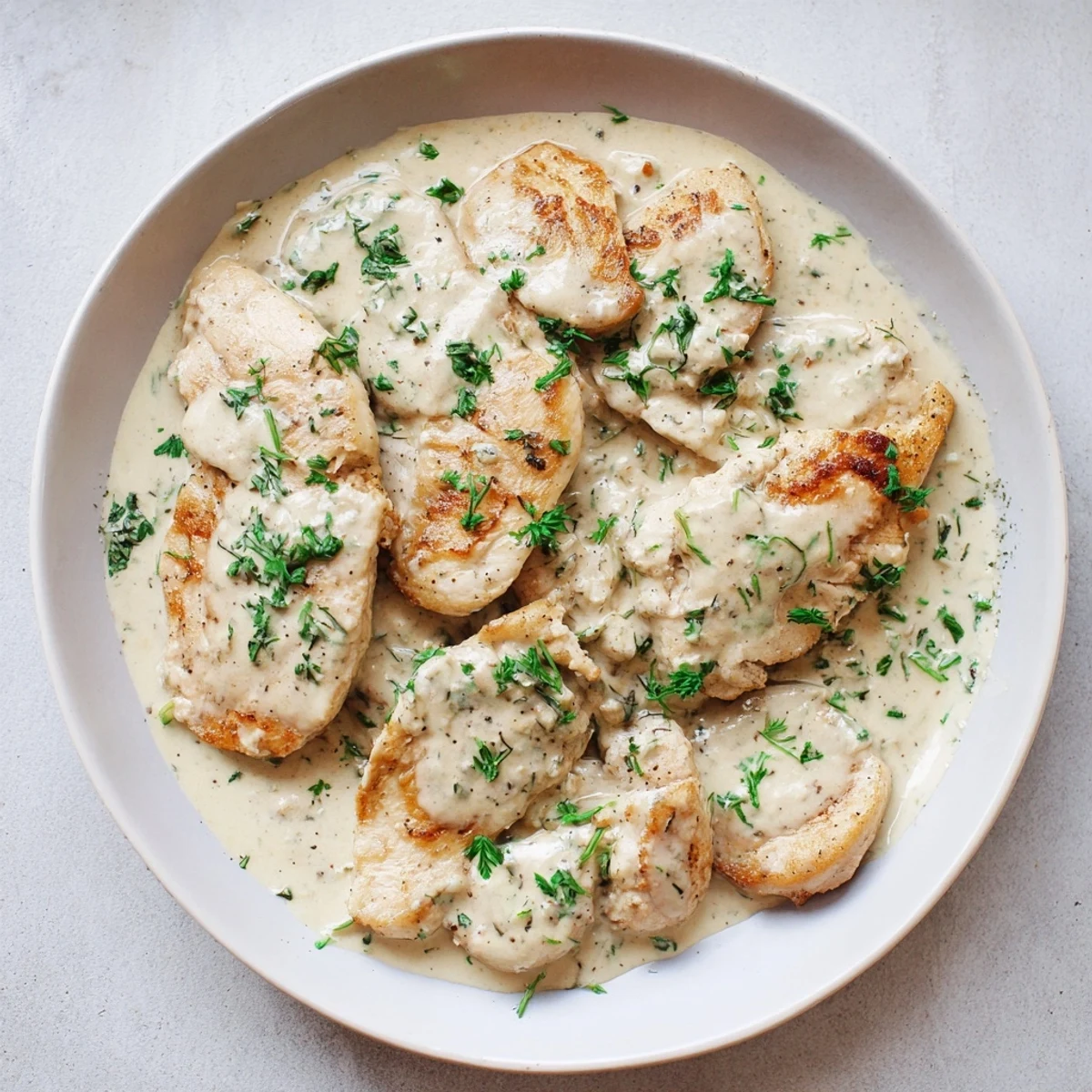 Lighter creamy tarragon chicken, golden seared, in a luscious sauce, perfect served with fresh herbs.