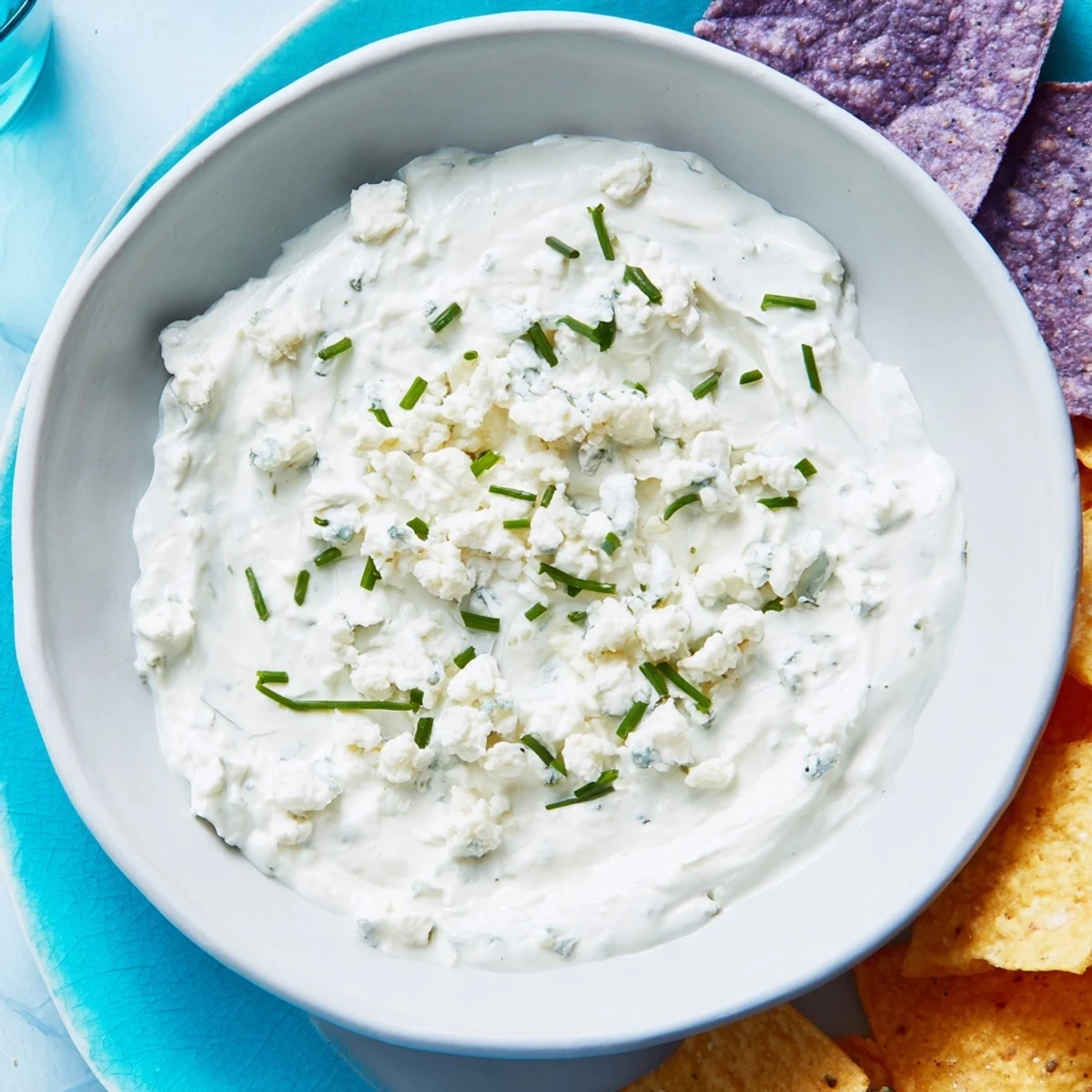 Frozen Pond Blue Dip Platter: A creamy blue cheese dip surrounded by colorful chips and fresh veggie dippers.