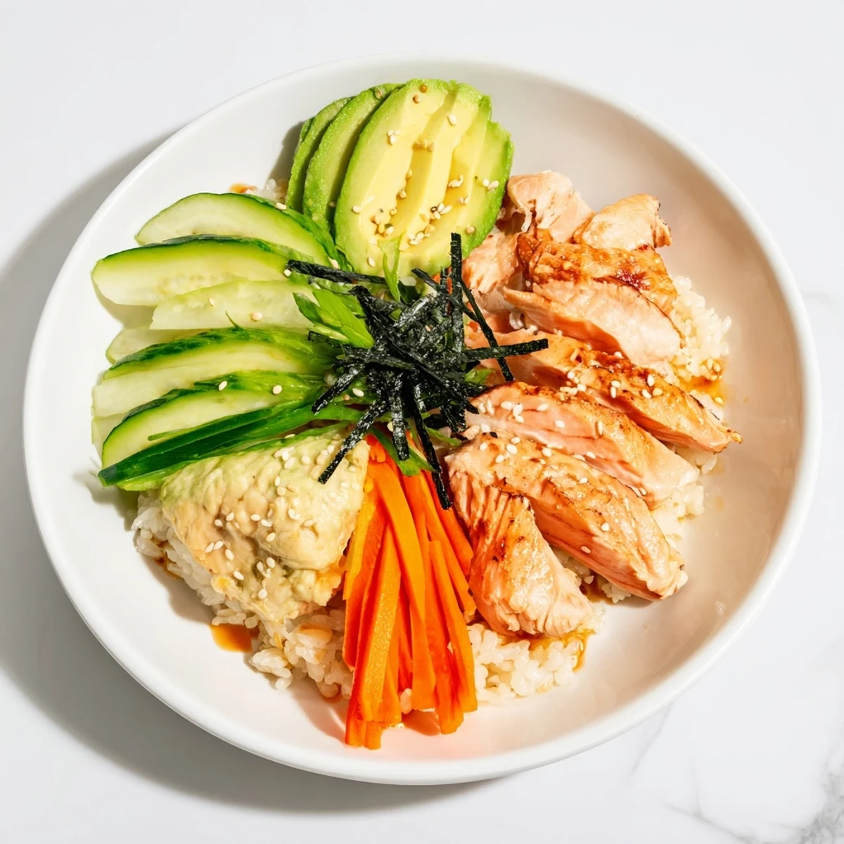 Japanese-style Salmon & Chicken Rice Bowls, featuring tender salmon, served with fresh cucumber and carrots.