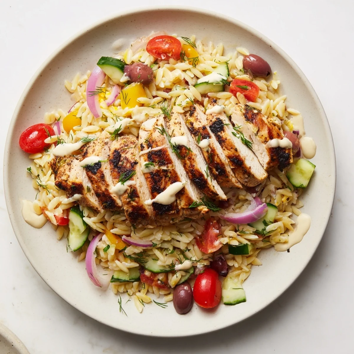 Vibrant Greek Chicken Gyro Pasta Bowls with grilled chicken, fresh veggies, and creamy feta drizzle.