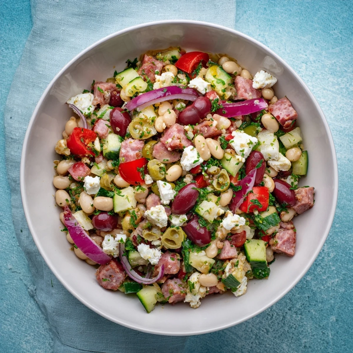 Mediterranean Bean Salad with salami, a colorful mix of beans and salami, beautifully presented.