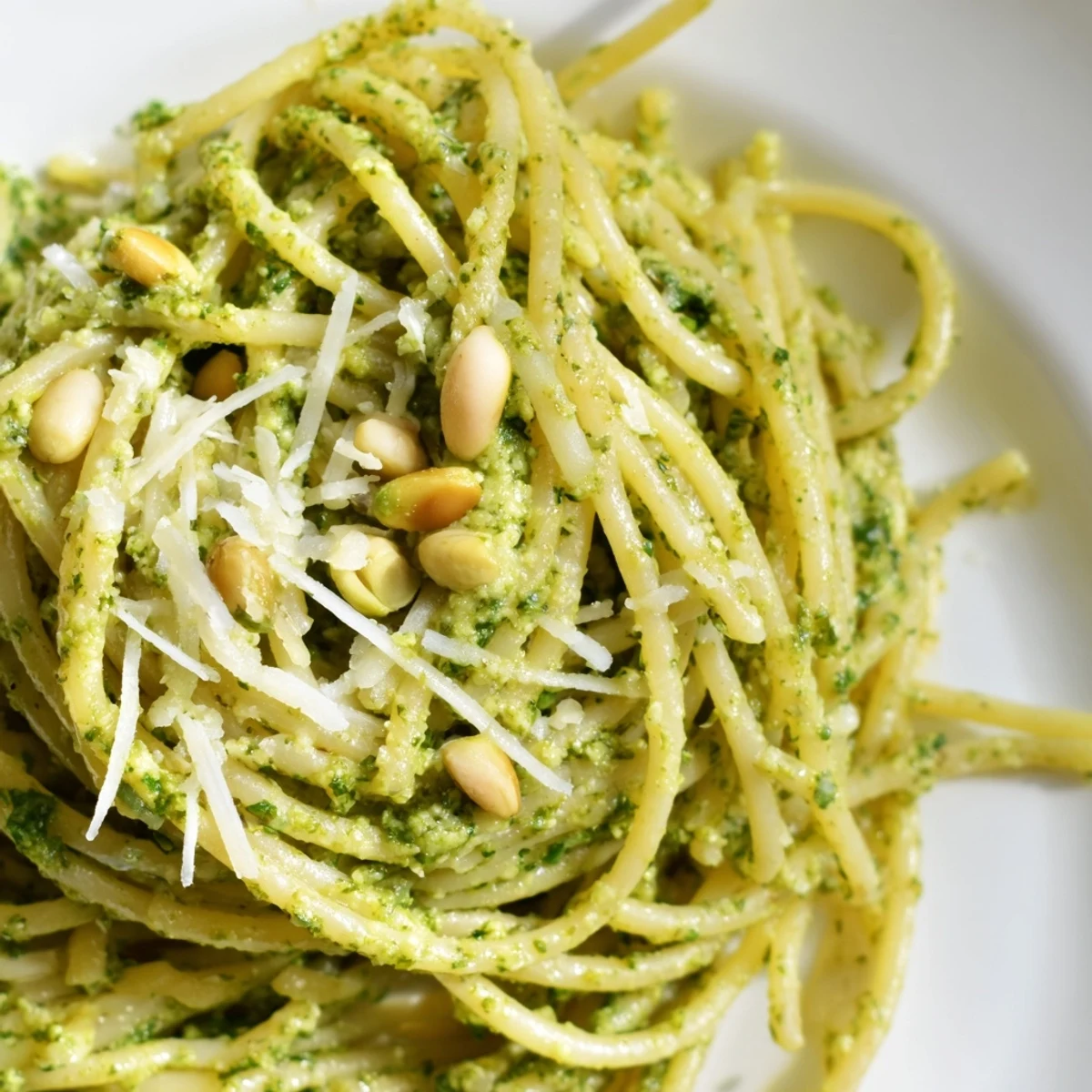 Freshly toasted sunflower seeds blend into a vibrant basil pesto tossed with pasta and cream, ready for a comforting vegetarian dinner.