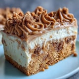 Decadent Baked Biscoff Cake with Creamy Lotus Frosting garnished with crumbled cookies on top. 