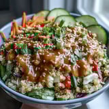 Thai Coconut Quinoa Bowl with fluffy grains, colorful vegetables, and a zesty peanut-lime dressing.  