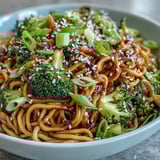 Savory Asian teriyaki noodle bowl with tender veggies and sesame garnish, ready for a quick weeknight meal.  