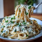 A comforting vegetarian pasta dish featuring silky Alfredo sauce and lightly caramelized cabbage.  