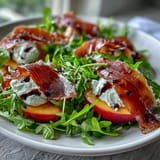 Vibrant Peach Burrata Prosciutto Salad featuring fresh basil and drizzled balsamic glaze.