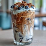 Savor this refreshing blueberry muffin iced coffee topped with sweet vanilla foam.