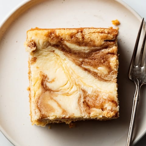 Indulge in Spiced Sweet Tea Cheesecake Blondies with a creamy swirl and lemon zest.  