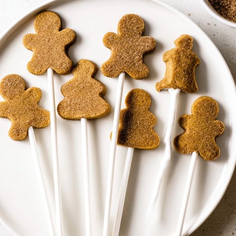 Delicious cinnamon sugar gingerbread cookie pops, adorned with festive holiday spices.
