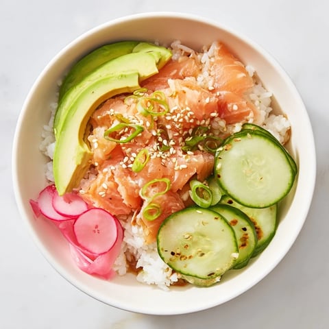 Leftover Salmon & Rice Bowl topped with fresh avocado and crisp cucumber slices  