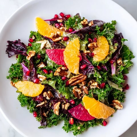 A colorful Winter Greens Salad with citrus, pomegranate, and toasted nuts, ready to enjoy.