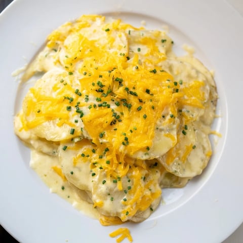 Golden-brown, bubbly cheesy scalloped potatoes, a comforting side dish perfect for any holiday meal.