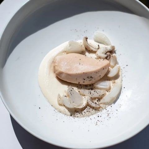 Ethereal The Ghostly Gala showcases poached chicken with creamy cauliflower purée and mushroom garnish, visually stunning.