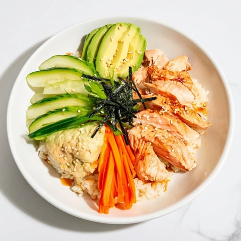 Japanese-style Salmon & Chicken Rice Bowls, featuring tender salmon, served with fresh cucumber and carrots.