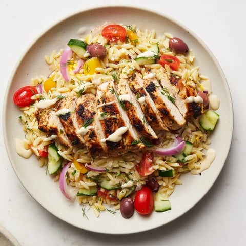 Vibrant Greek Chicken Gyro Pasta Bowls with grilled chicken, fresh veggies, and creamy feta drizzle.