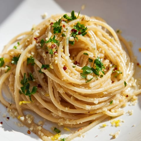 Golden Garlic Butter Noodles, perfectly coated with a glistening, flavorful sauce, ready to serve.