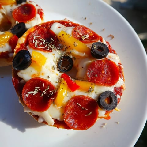 Golden, bubbly mini bagel pizzas with melted mozzarella and savory pepperoni topping.