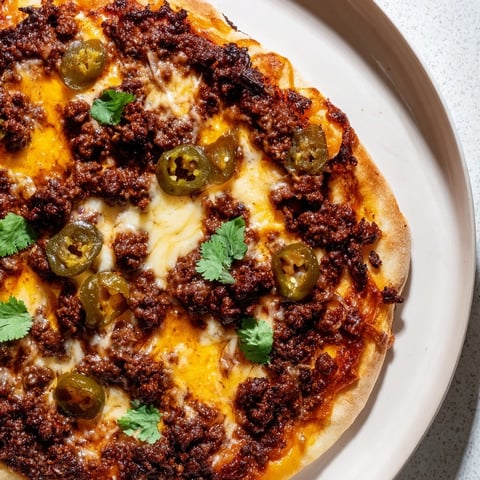 Spicy ground beef pizza with bubbling cheese, a delicious homemade dinner, ready to eat.