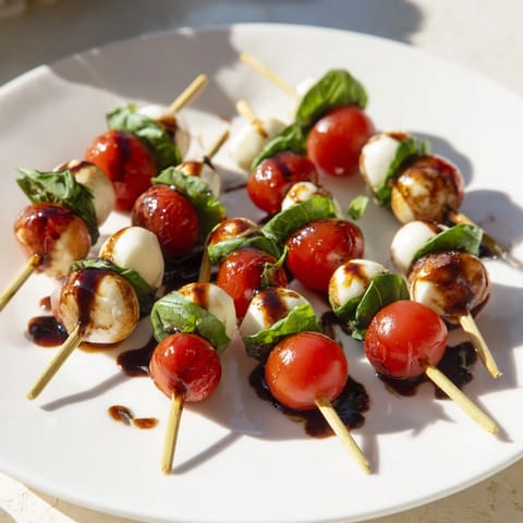 Sweet, vibrant Mini Caprese Skewers stacked high, perfect appetizer for summer picnics.