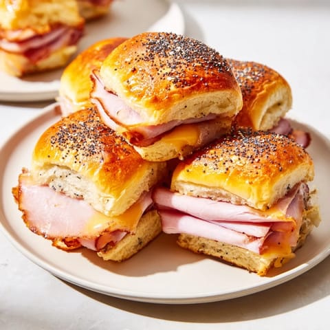 Warm Baked Ham and Cheese Party Sliders feature gooey Swiss and a buttery, glazed topping.