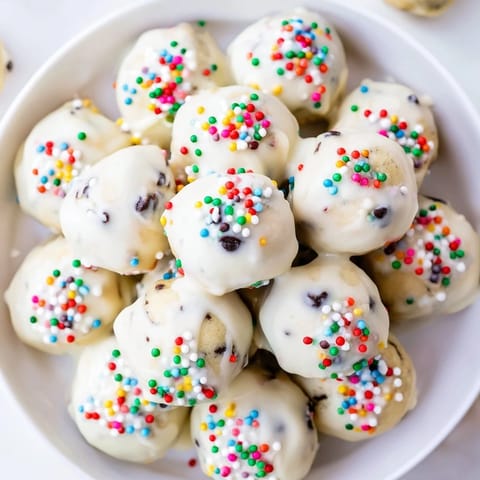 Soft and tender Protein-Packed Italian Christmas Cookie Balls coated in a sweet glaze and festive sprinkles.