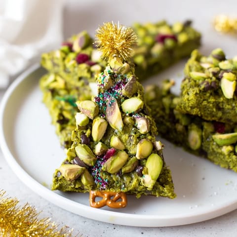Chewy Matcha Pistachio Christmas Tree Blondie Bars, offering a delightful combination of earthy matcha and crunchy nuts on display.