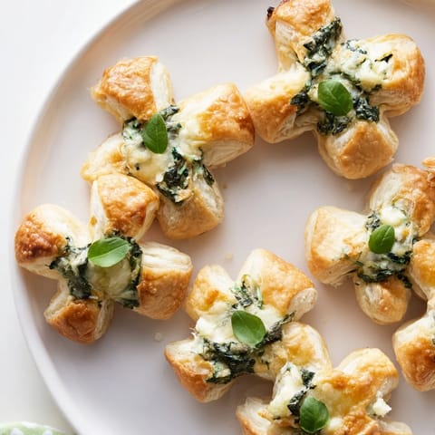 Fresh basil leaves crown each baked Lucky Clover St. Patrick's Day Bite, a savory appetizer.