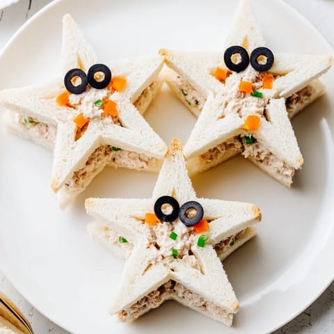 These charming Mini Starfish Sandwiches feature tuna filling visible between crustless bread star shapes.