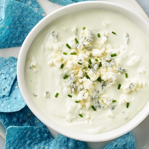Party-ready Frozen Pond Blue Dip Platter with vibrant chips, veggies, and a beautiful blue cheese dip.