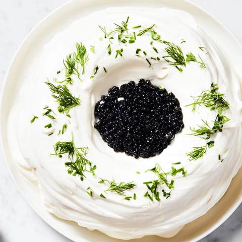 Delicious Diamond Inlay appetizer shows black caviar center ringed by fluffy cream cheese, perfect for a party.