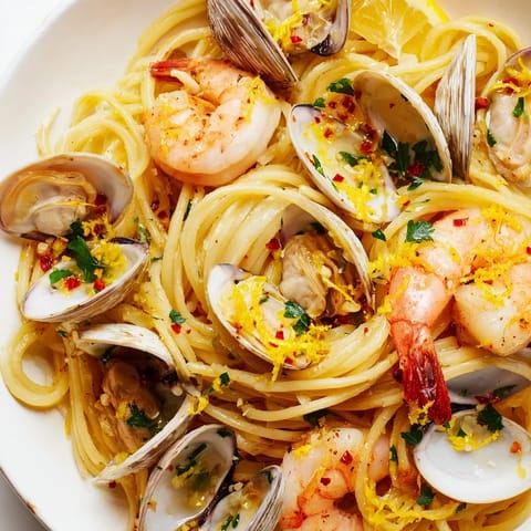 Close-up of Seafood Pasta Aglio e Olio showcasing perfectly cooked spaghetti coated in garlic-infused olive oil.