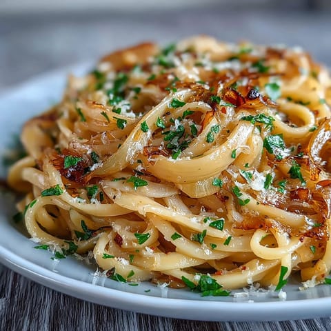 Hearty Cabbage Pasta With Garlic and Parmesan served warm in a white bowl, garnished with lemon zest.