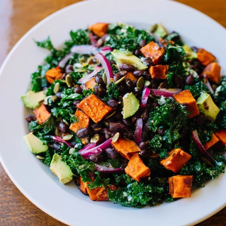 This easy Massaged Kale Salad with Black Beans & Sweet Potato features roasted sweet potato and creamy avocado.