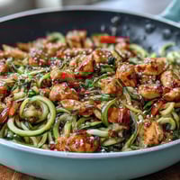 Healthy Easy Zucchini Noodle Stir Fry with Chicken - colorful, tender chicken and spiralized zucchini noodles stir-fried with crisp vegetables in a savory Asian sauce.