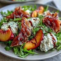 Peach Burrata Prosciutto Salad: creamy burrata, ripe peaches, and savory prosciutto.